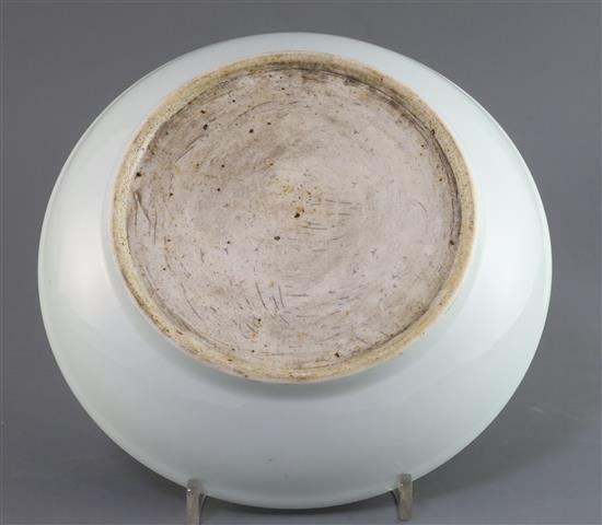 A Chinese pale celadon glazed dragon dish, D. 24.7cm